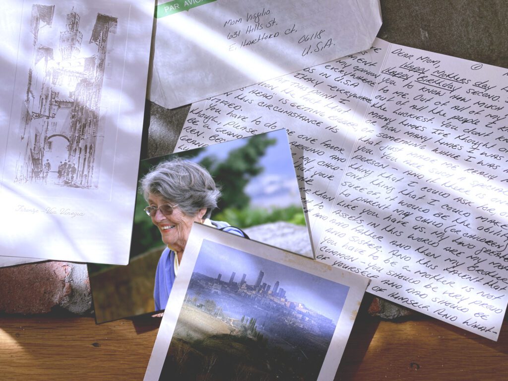 Handwritten letters and photographs scattered across a table